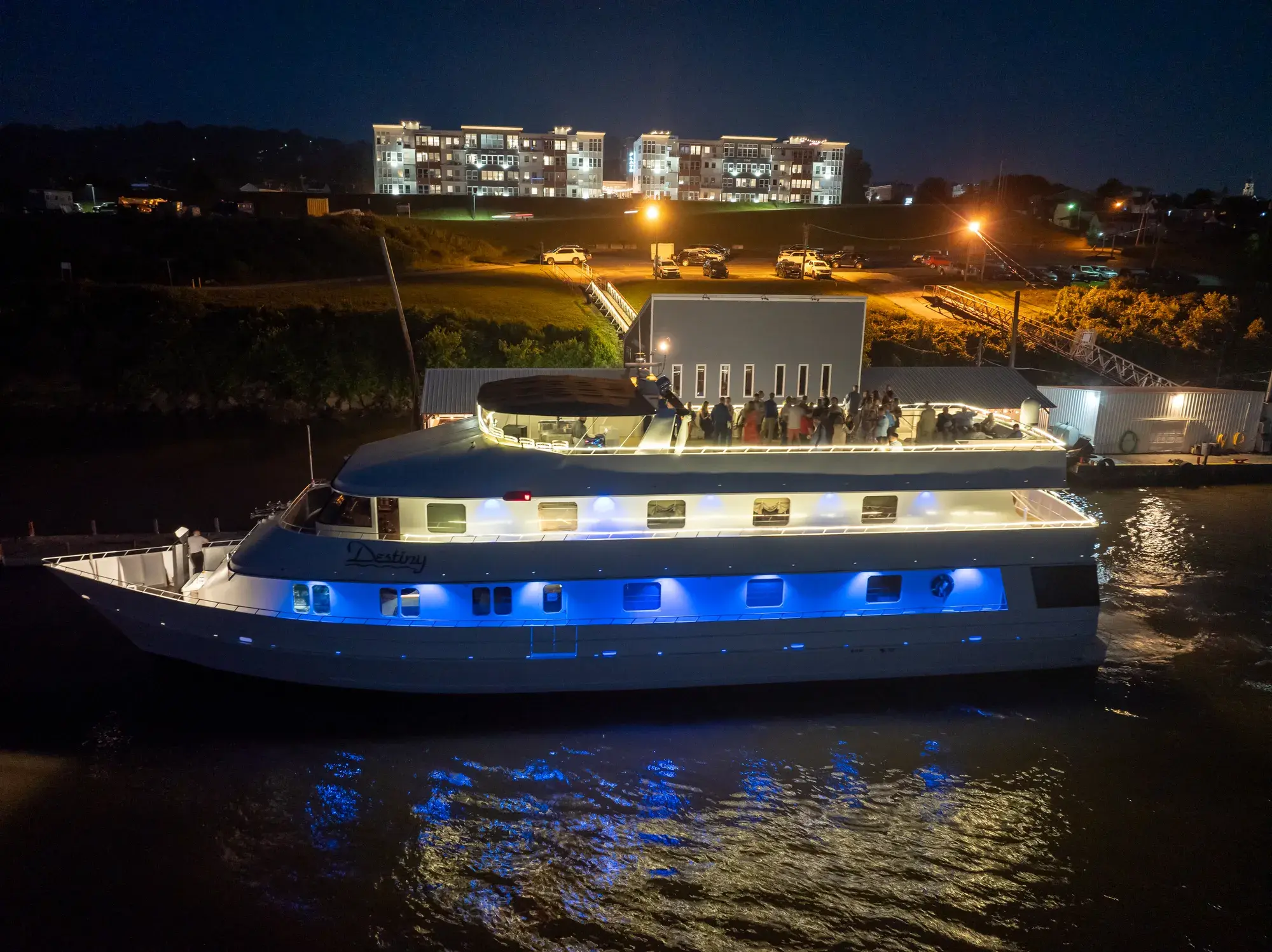 The Destiny party yacht glowing with lights after dark