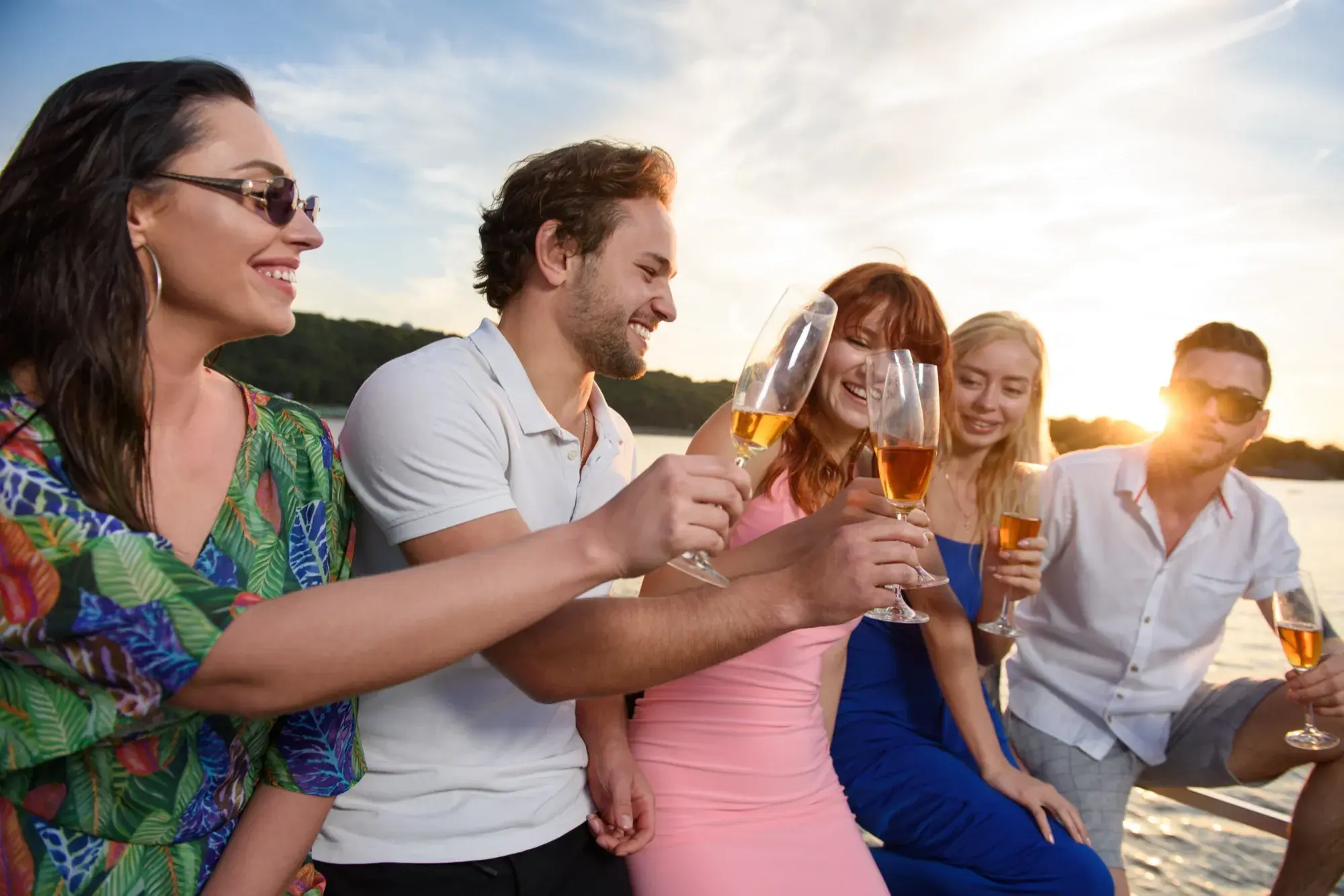 Guests toasting champagne on the water